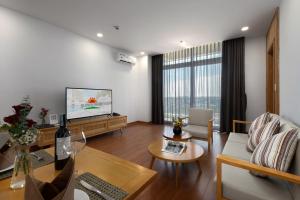 a living room with a couch and a tv at Sunflower International Village in Hai Phong