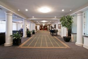 a hallway with a grand piano in a building at Chateau Lacombe Hotel in Edmonton