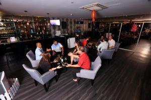 a group of people sitting in a bar at Apple Hotel Penang in George Town