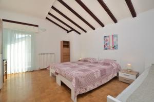 sypialnia z łóżkiem z fioletową kołdrą w obiekcie Apartment Reno w mieście Umag