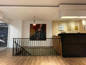 a staircase in a room with a painting on the wall at Yoshi Hotel in Tainan