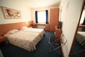 Postel nebo postele na pokoji v ubytování Hotel Matriz