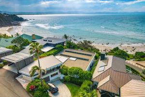 an aerial view of a house and the beach at Baywatch at Wategos in Byron Bay
