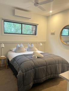 a bedroom with a large bed with a ceiling fan at Bundalong Villas in Bundalong