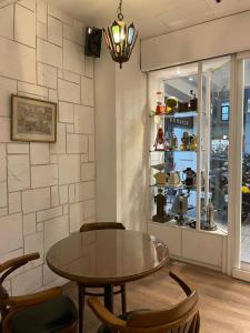 a dining room with a table and chairs and a window at Yoshi Hotel in Tainan