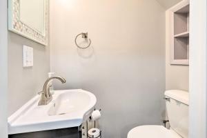 a white bathroom with a sink and a toilet at Ellicottville Townhome about Half Mi to Slopes! in Ellicottville +16 photos
