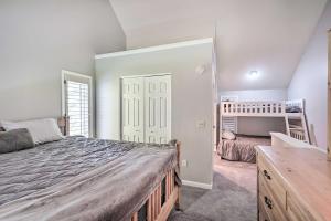 a bedroom with a bed and a large mirror at Ellicottville Townhome about Half Mi to Slopes! in Ellicottville