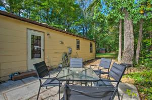 a patio with a table and chairs in front of a house at Quaint Hinton Hideaway - Hunt and Fish Nearby! in Hinton