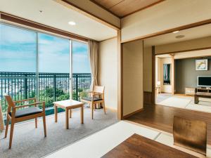 a living room with a view of a balcony at KAMENOI HOTEL Setouchi Hikari in Hikari
