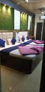 a group of four beds in a room at Hotel Shehnaz Inn - Walking Distance for Golden Temple in Amritsar