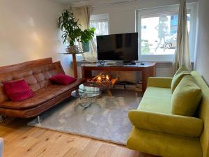 a living room with a couch and a fireplace at Royal Apartment 02 in Schaan