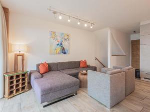 a living room with a couch and a chair at Fantastic chalet with sauna in Niedernsill