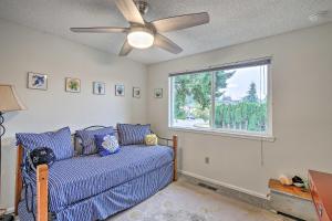 a living room with a blue couch and a window at Spacious Kent Getaway with Yard, Deck and Grill! in Kent