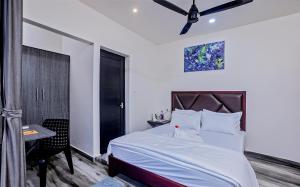 a bedroom with a bed and a desk and a window at Dune Homestay in Alleppey