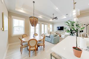 a dining room and living room with a table and chairs at Prominence Moby Dick in Inlet Beach
