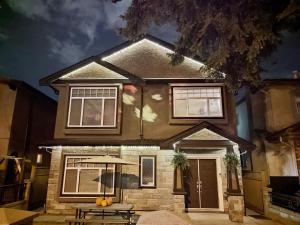 a house with a picnic table in front of it at Private Suite w King Bed, Ground Level, Naturally Bright in Vancouver