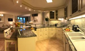 a kitchen with white cabinets and a counter with fruits on it at Deluxe - Le millésime - Calme in Strasbourg