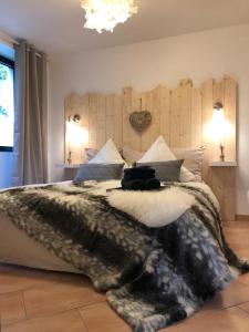 a bedroom with a large bed with a blanket on it at Deluxe - Le millésime - Calme in Strasbourg
