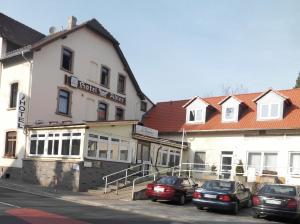 eine Gruppe von Autos, die vor einem Gebäude geparkt sind in der Unterkunft Hotel zum Adler in Bad Homburg vor der Höhe