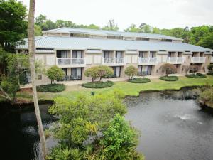 an apartment building with a pond in front of it at Players Club Resort, a VRI resort in Hilton Head Island