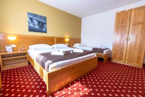 Postelja oz. postelje v sobi nastanitve Hotel Bau Maribor