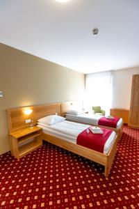 Postelja oz. postelje v sobi nastanitve Hotel Bau Maribor