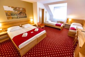 Postelja oz. postelje v sobi nastanitve Hotel Bau Maribor