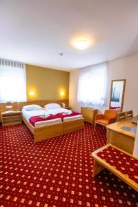 Postelja oz. postelje v sobi nastanitve Hotel Bau Maribor