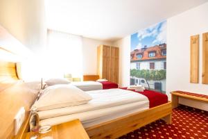 Postelja oz. postelje v sobi nastanitve Hotel Bau Maribor
