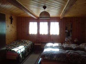 a bedroom with two beds and a window at 2 bedroom chalet with a mountain view in Saint-Jean