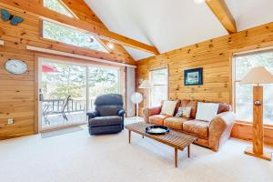 a living room with a couch and a table at Marwood Lake Cottage in Wakefield