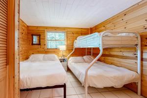 a bedroom with two bunk beds in a cabin at Marwood Lake Cottage in Wakefield