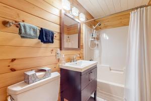 a bathroom with a white toilet and a sink at Marwood Lake Cottage in Wakefield +23 photos