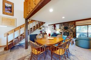 a living room with a wooden table and chairs at Snowcreek 56 in Mammoth Lakes