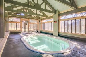 a hot tub in a large room with windows at Snowcreek 56 in Mammoth Lakes