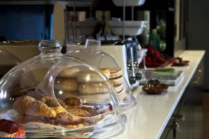 a counter with a glass dish of pastries on it at Aurora Hotel in Avalon