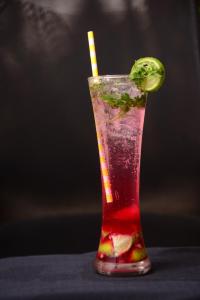 a drink with a lime and a straw at The Hawaii Comforts Panjim in Panaji