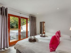 a bedroom with a bed with slippers on it at Waterside Lodge Five -uk38263 in Southowram