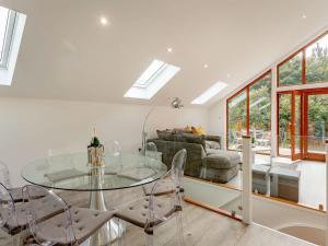 a dining room with a glass table and chairs at Waterside Lodge Five -uk38263 in Southowram