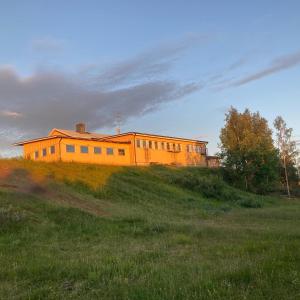 an orange building on top of a grassy hill at Kuttainen Lodge in Karesuando