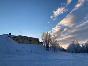 a building on top of a snow covered hill at Kuttainen Lodge in Karesuando