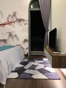 a bedroom with a bed and a television and a window at Hotel My Cang in Trà Vinh +38 photos