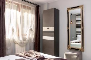 a bedroom with a mirror and a bed at Mon Ami Apart in Studentski Grad Area in Sofia