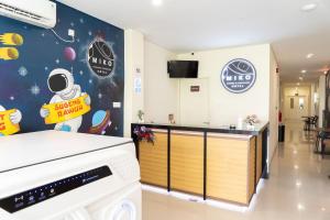 una cocina con lavavajillas y algunas señales en la pared en Miko Rooms & Capsules hotel, en Bungurasih