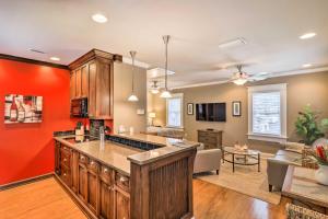 an open kitchen and living room with red walls at Hyde Park Luxury Studio with Prime Location! in Tampa