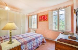 a bedroom with a bed and a desk and windows at 3 Bedroom Lovely Home In Camaiore in Camaiore