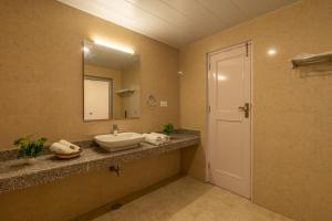 a bathroom with a sink and a mirror at The 14 Gables, A Boutique Stay in Manāli