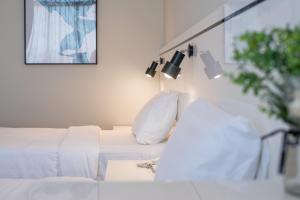 a bedroom with a white bed with lights on it at Grace Samudera Hotel in Semporna