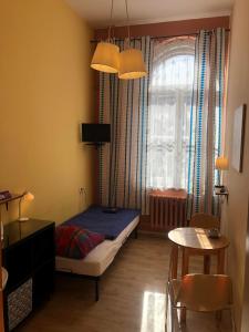 a small bedroom with a bed and a window at U Szermierzy in Wrocław