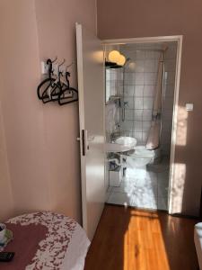 a bathroom with a shower and a toilet and a sink at U Szermierzy in Wrocław